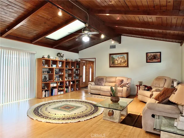 a living room with lots of furniture and a chandelier