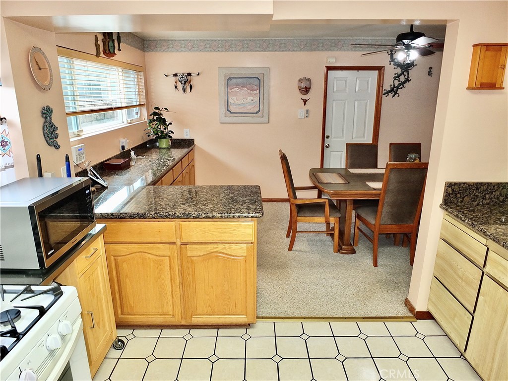 4907 139th Street Hawthorne, CA 90250 - Photo 24 of 47 a kitchen with stainless steel appliances granite countertop a stove a sink and a microwave