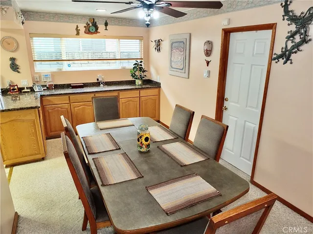 a view of a dining room with furniture and a window