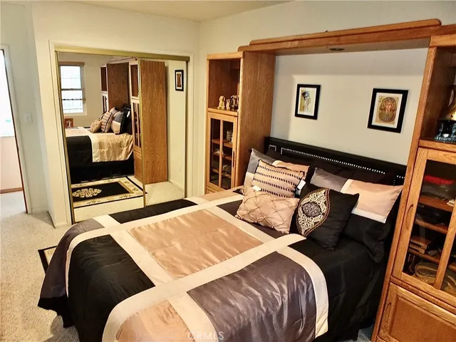 a bedroom with a bed and glass door