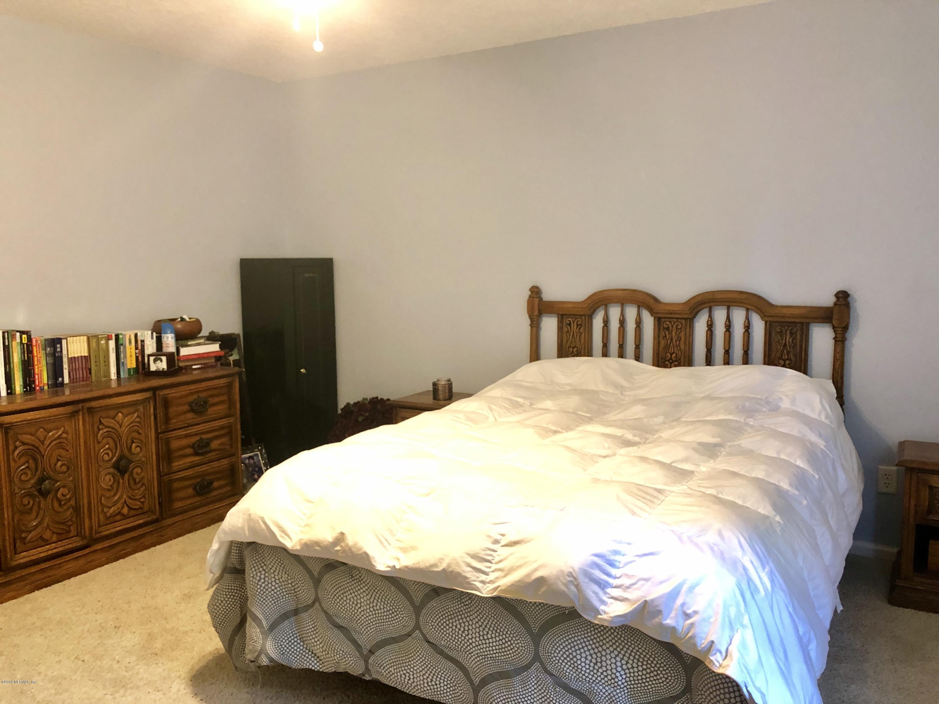 2457 Mallory Hills Road Jacksonville, FL 32221 - Photo 14 of 20 a bedroom with a bed and dresser