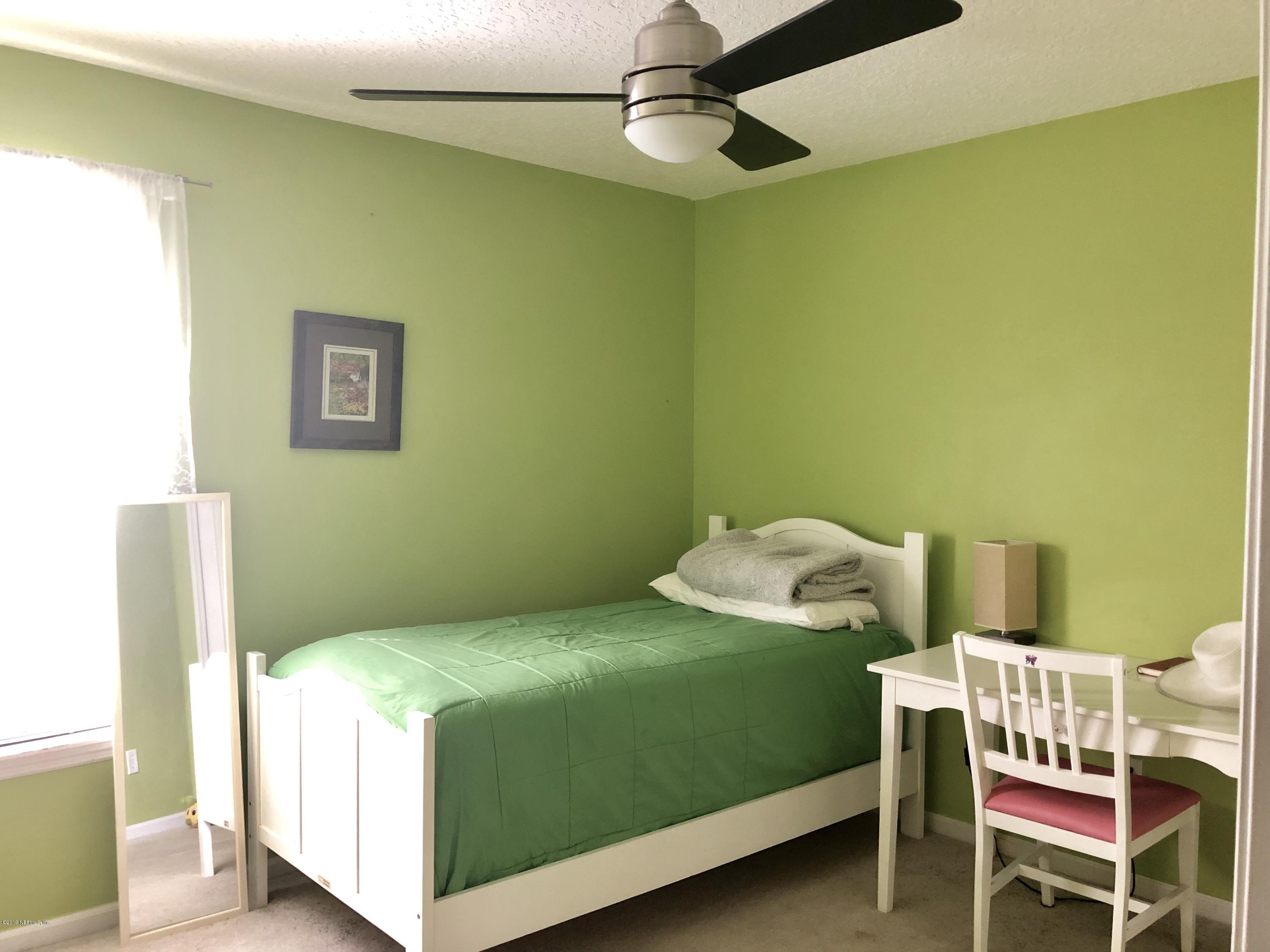2457 Mallory Hills Road Jacksonville, FL 32221 - Photo 15 of 20 a bedroom with a bed and a window