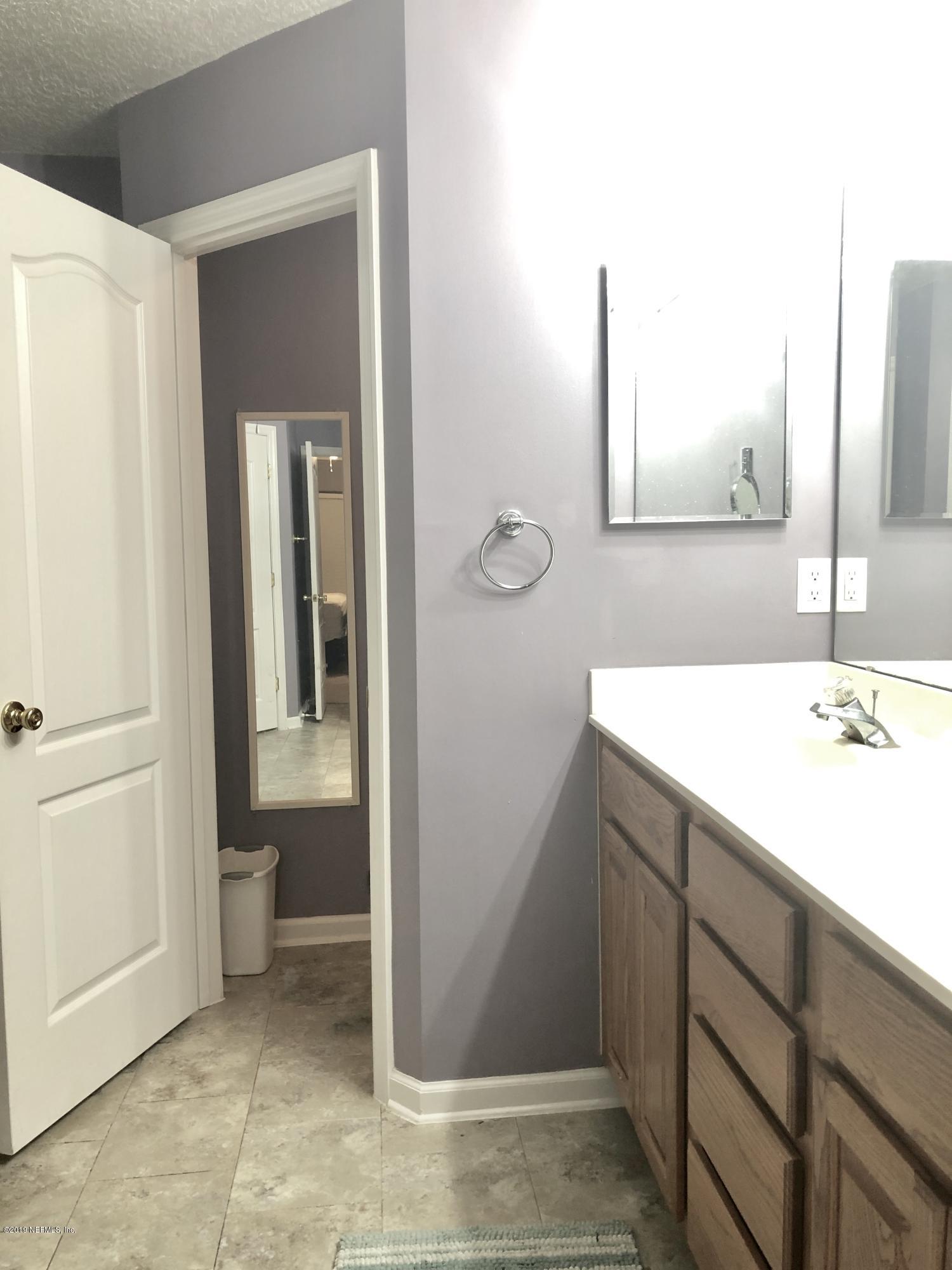 2457 Mallory Hills Road Jacksonville, FL 32221 - Photo 16 of 20 a bathroom with a sink and a mirror