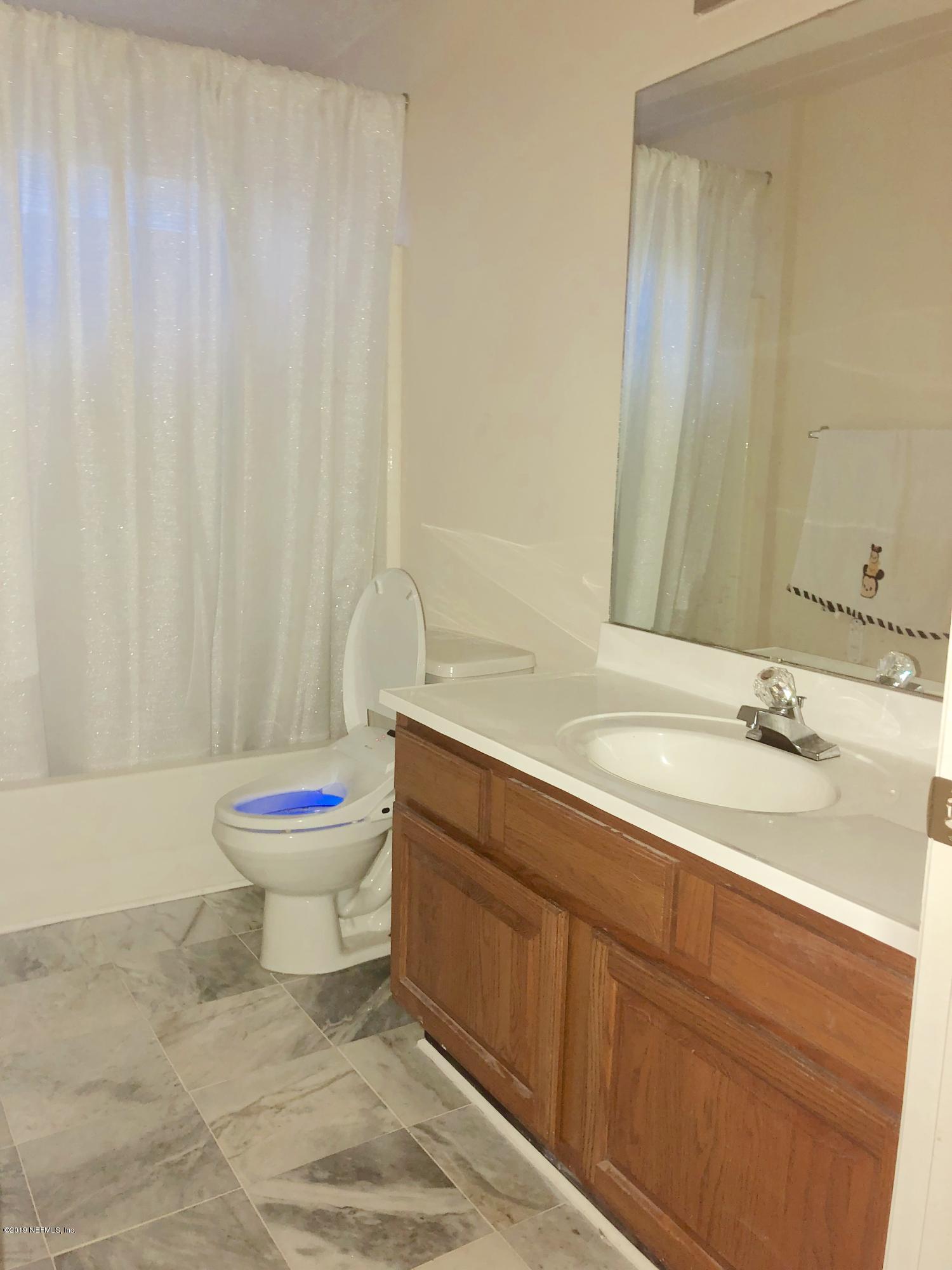 2457 Mallory Hills Road Jacksonville, FL 32221 - Photo 17 of 20 a bathroom with a sink and a toilet