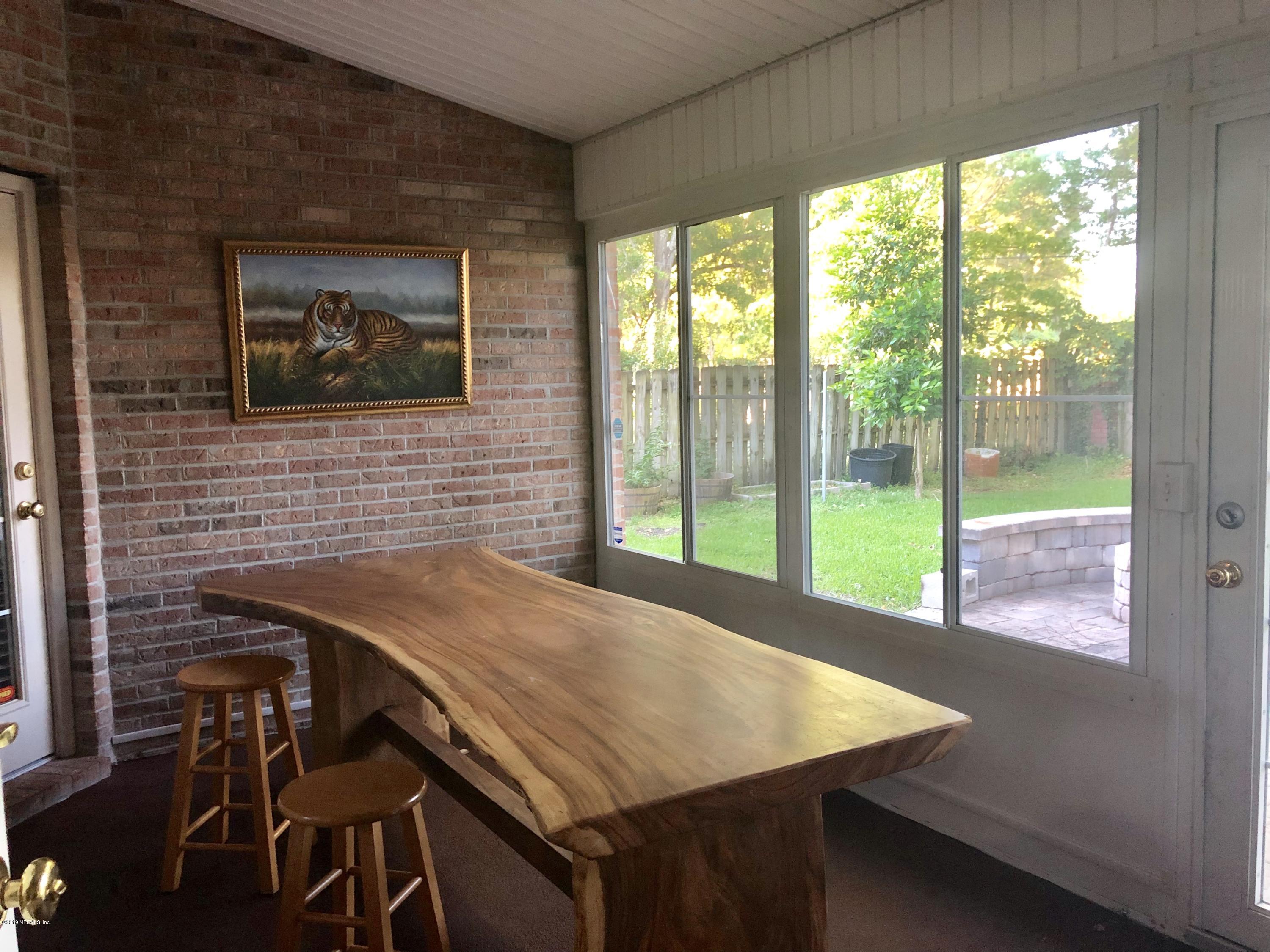 2457 Mallory Hills Road Jacksonville, FL 32221 - Photo 18 of 20 a dinning table sitting next to a window
