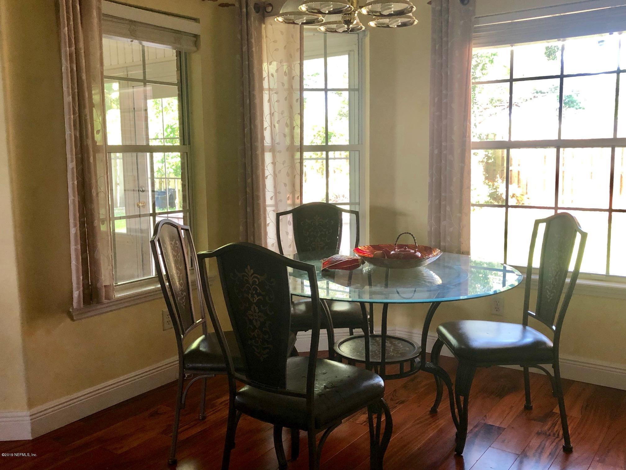 2457 Mallory Hills Road Jacksonville, FL 32221 - Photo 6 of 20 a view of a dining room with furniture and wooden floor