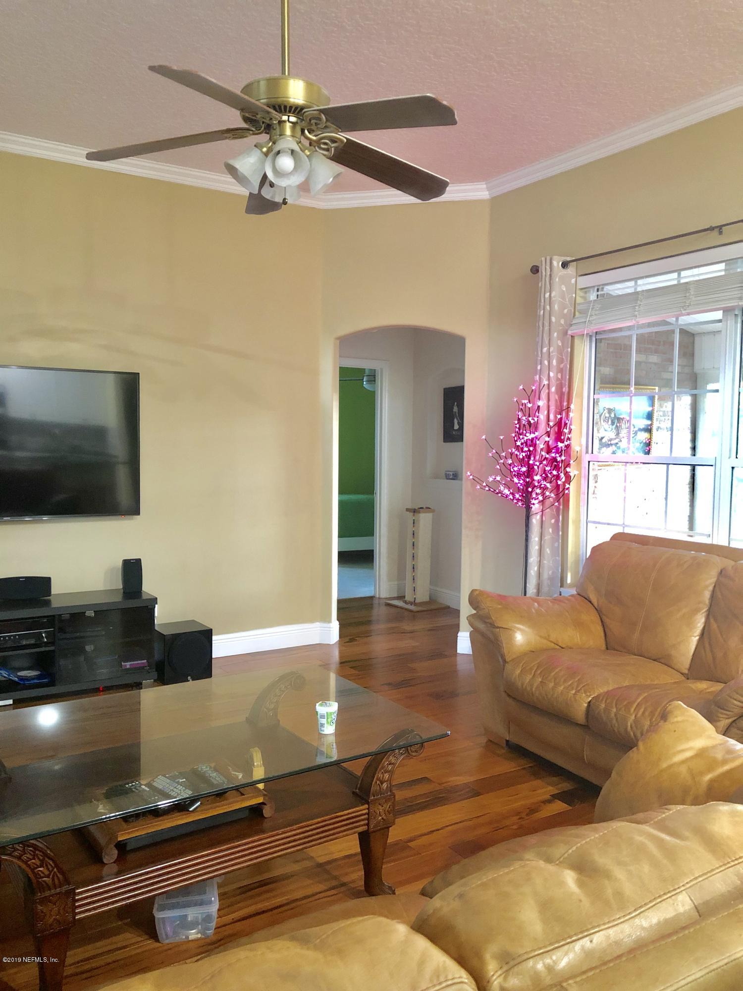 2457 Mallory Hills Road Jacksonville, FL 32221 - Photo 8 of 20 a living room with furniture and a flat screen tv