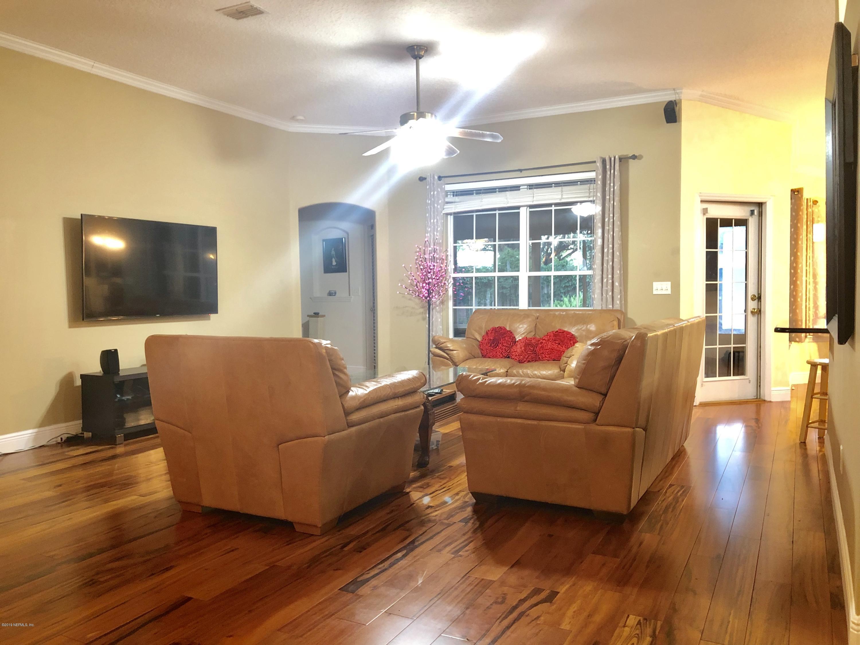 2457 Mallory Hills Road Jacksonville, FL 32221 - Photo 9 of 20 a living room with furniture and a flat screen tv