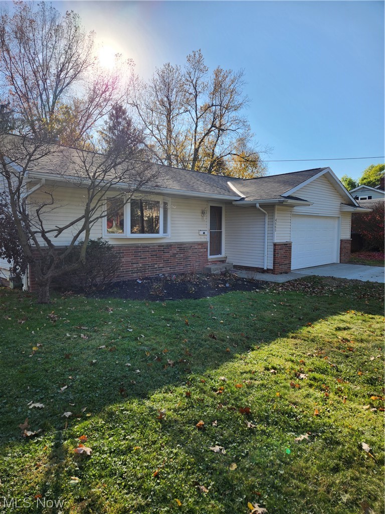 4660 West Farnhurst Road South Euclid, OH 44121 - Photo 2 of 17 View of front facade featuring a garage and a front lawn