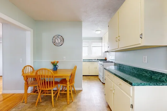 a dining room with furniture and a window