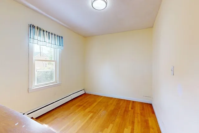 a room with window and bed