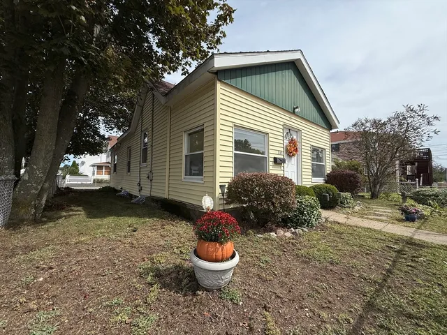 a backyard of a house with fountain table and chairs