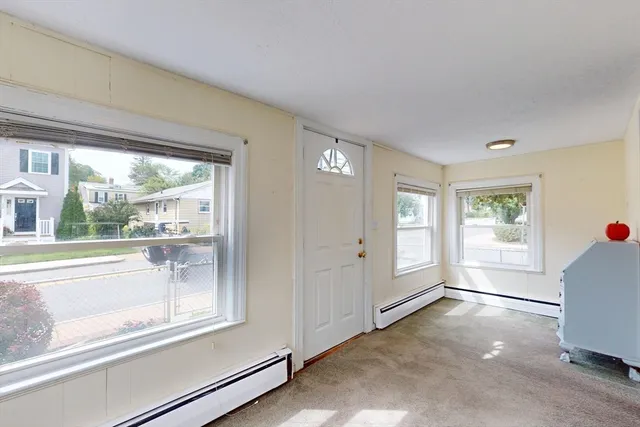 a view of hallway with stairs and a window