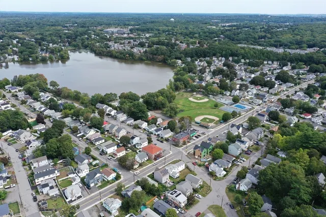 an aerial view of residential houses with outdoor space and river