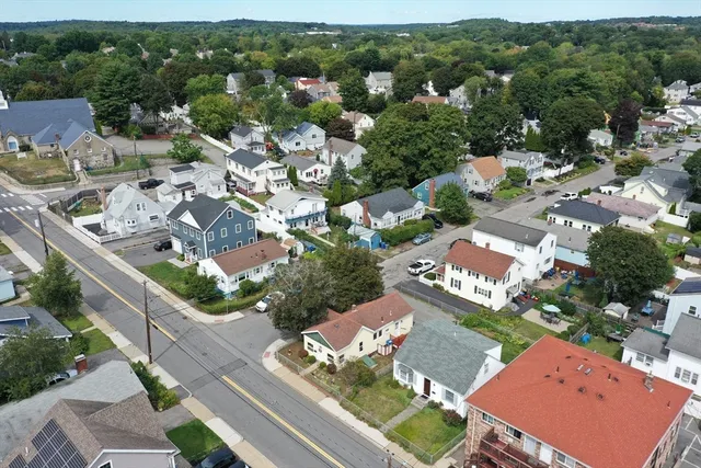 an aerial view of a house with a yard basket ball court and outdoor seating