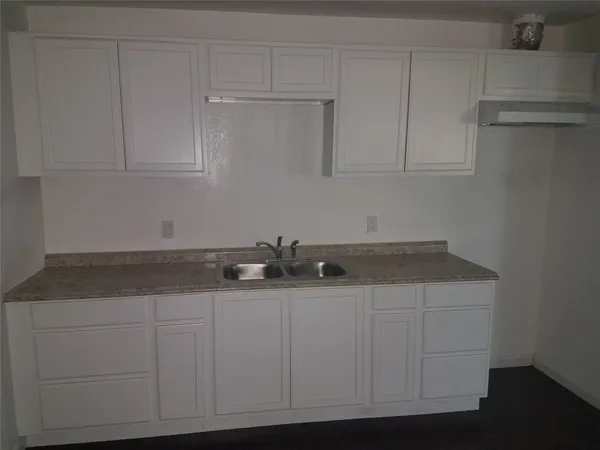 a kitchen with white cabinets