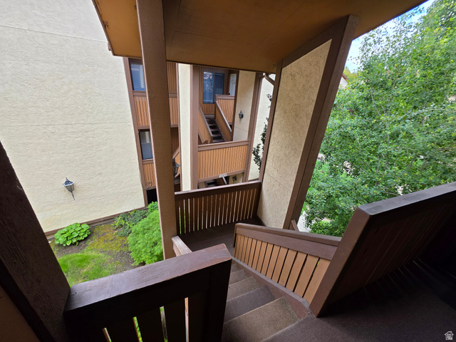6852 Countrywoods Circle, Unit 5D Midvale, UT 84047 - Photo 4 of 50 Exterior staircase featuring brown wood-finish railings and risers