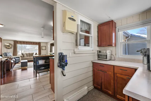 a kitchen with granite countertop a sink and cabinets