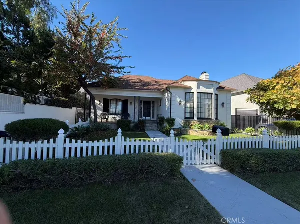 a view of a house with a yard deck and a garden