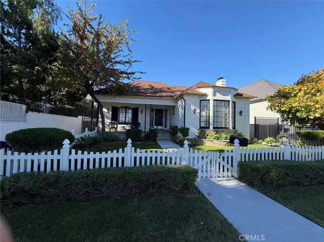 a view of a house with a yard deck and a garden