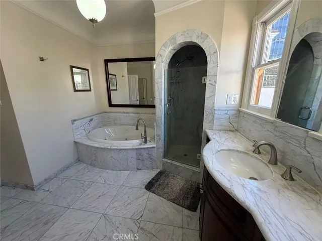 a bathroom with a granite countertop sink mirror vanity and bathtub