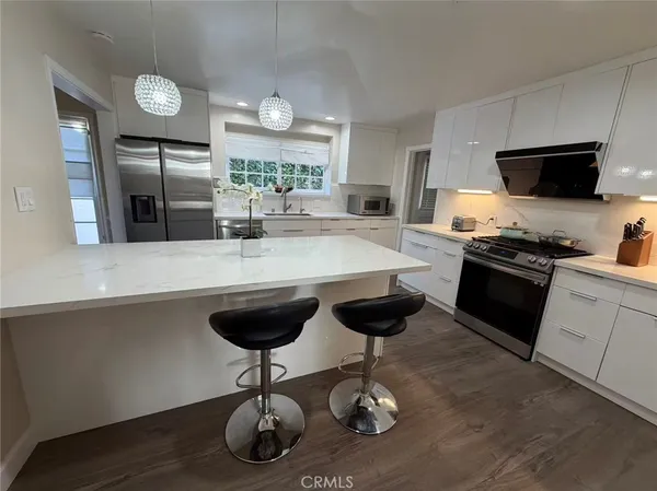 a kitchen with a counter space cabinets and appliances