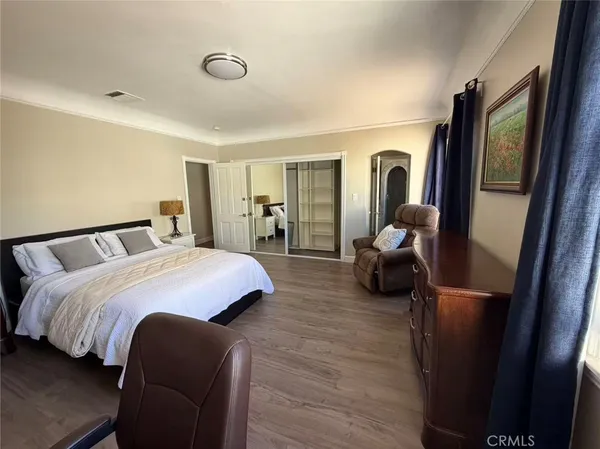 a bedroom with a bed and a mirror