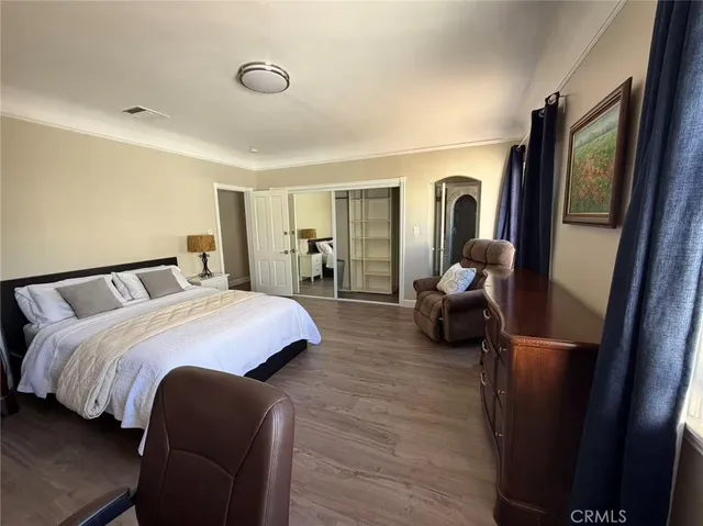 a bedroom with a bed and a mirror