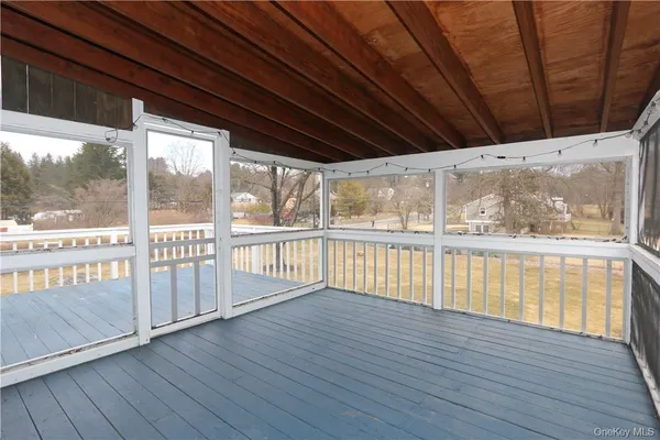 a view of balcony with wooden floor