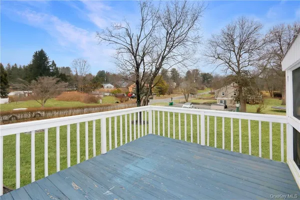 a view of balcony with wooden floor and fence