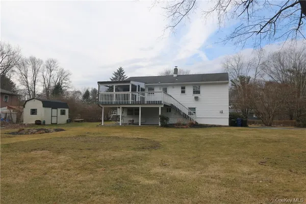 a view of a yard with a house and a tree