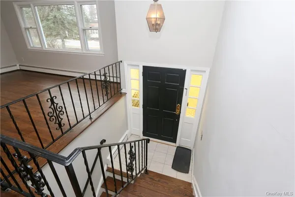a view of entryway with wooden floor and stairs