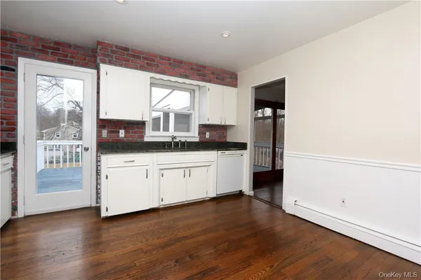 a kitchen with a refrigerator and window