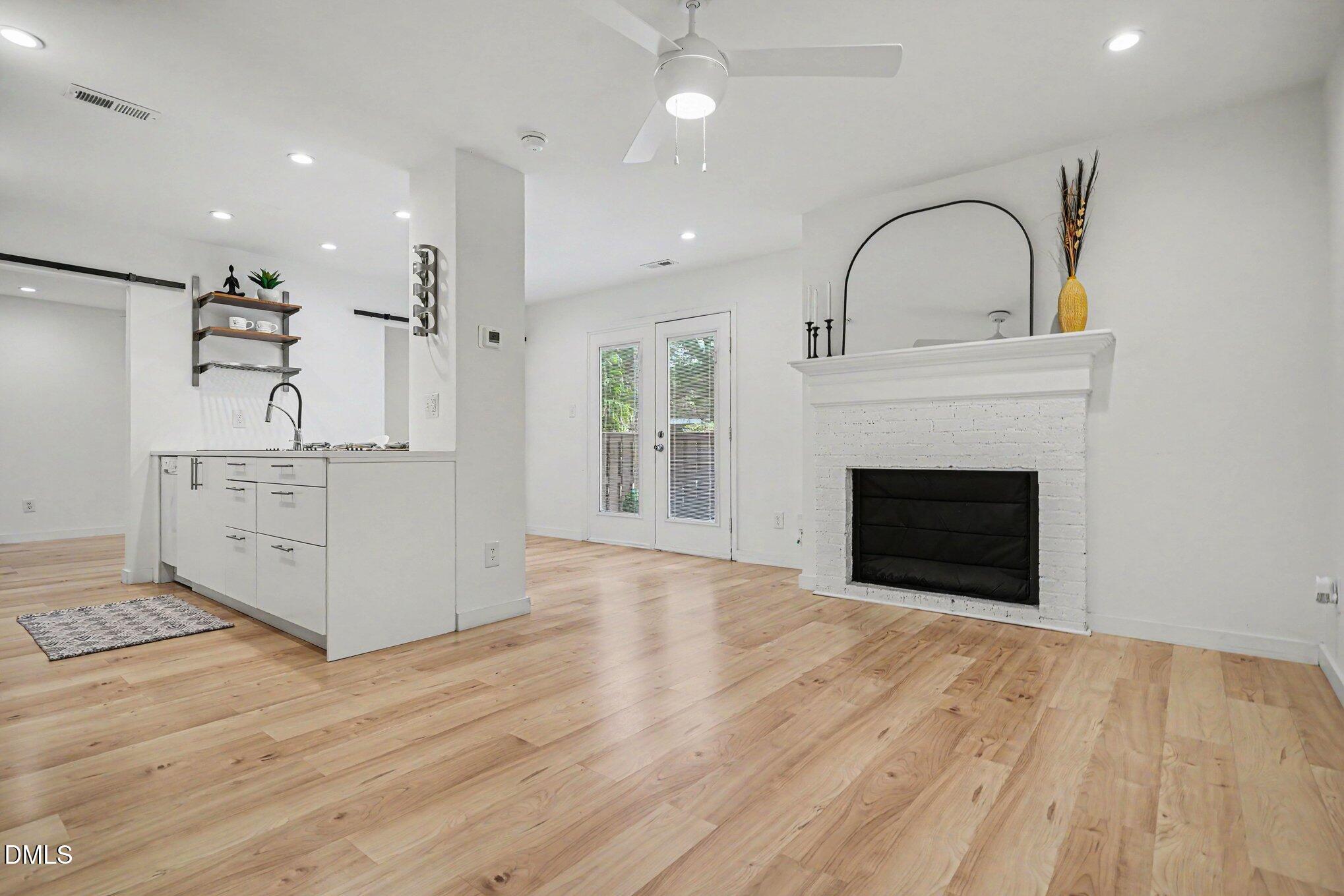 3555 Mill Run Raleigh, NC 27612 - Photo 2 of 25 a view of a kitchen with a sink and a stove top oven