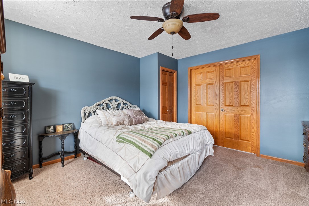 4363 Wile Road Wooster, OH 44691 - Photo 20 of 36 Carpeted bedroom with a textured ceiling and ceiling fan