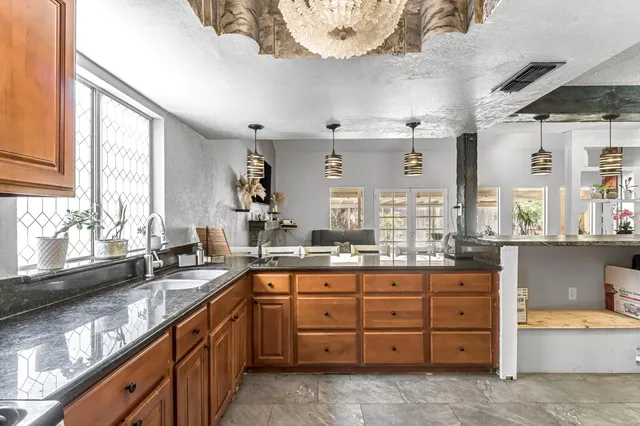 a kitchen with lots of counter space and windows