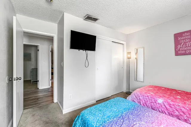 a bedroom with a bed and a flat screen tv