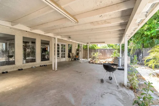 a view of a bedroom with table and chairs
