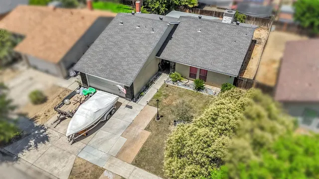 an aerial view of a house with a yard