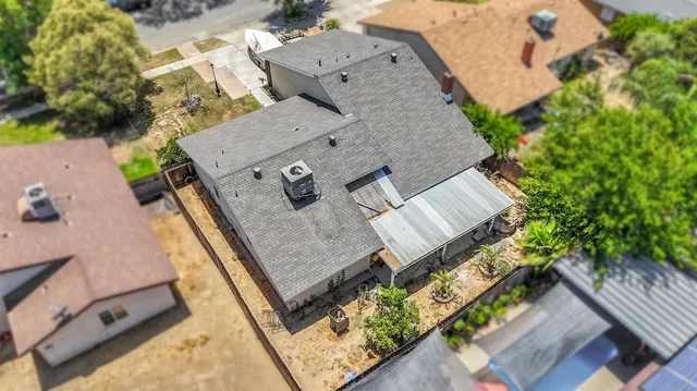 an aerial view of a house with a swimming pool
