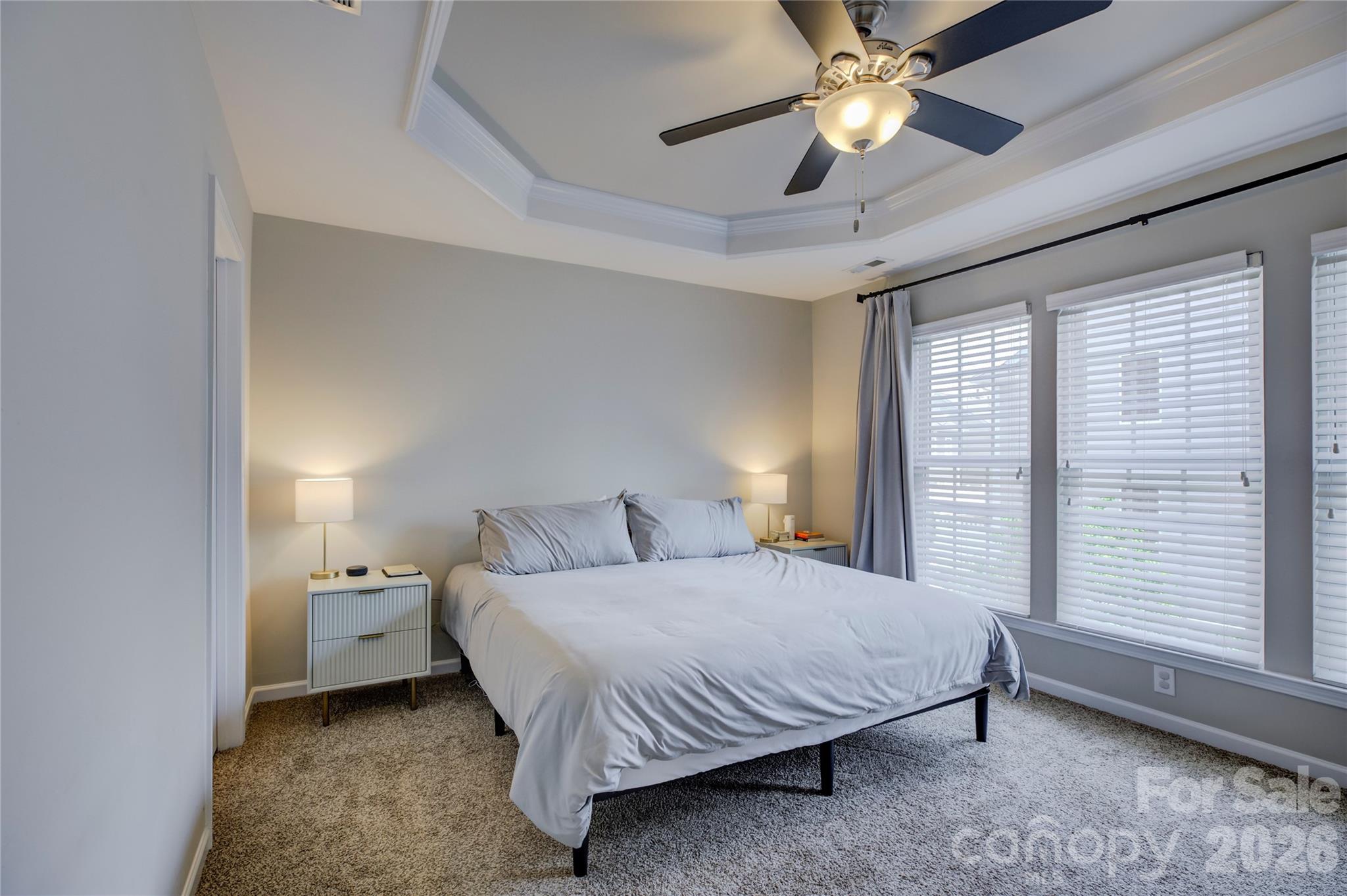629 6th Baxter Crossing Fort Mill, SC 29708 - Photo 29 of 48 a bedroom with a bed and a chandelier