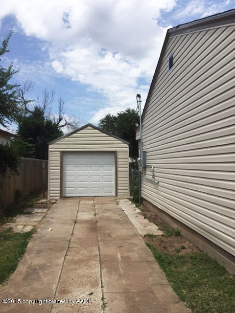 115 Southeast 40th Avenue Amarillo, TX 79110 - Photo 8 of 10 a front view of a house with a yard and garage