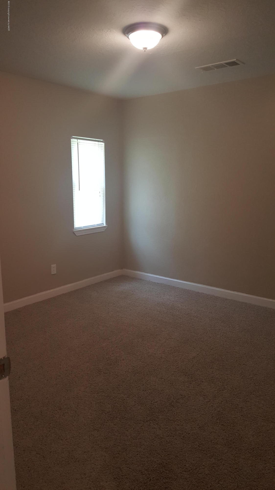 115 Southeast 40th Avenue Amarillo, TX 79110 - Photo 9 of 10 an empty room with a window