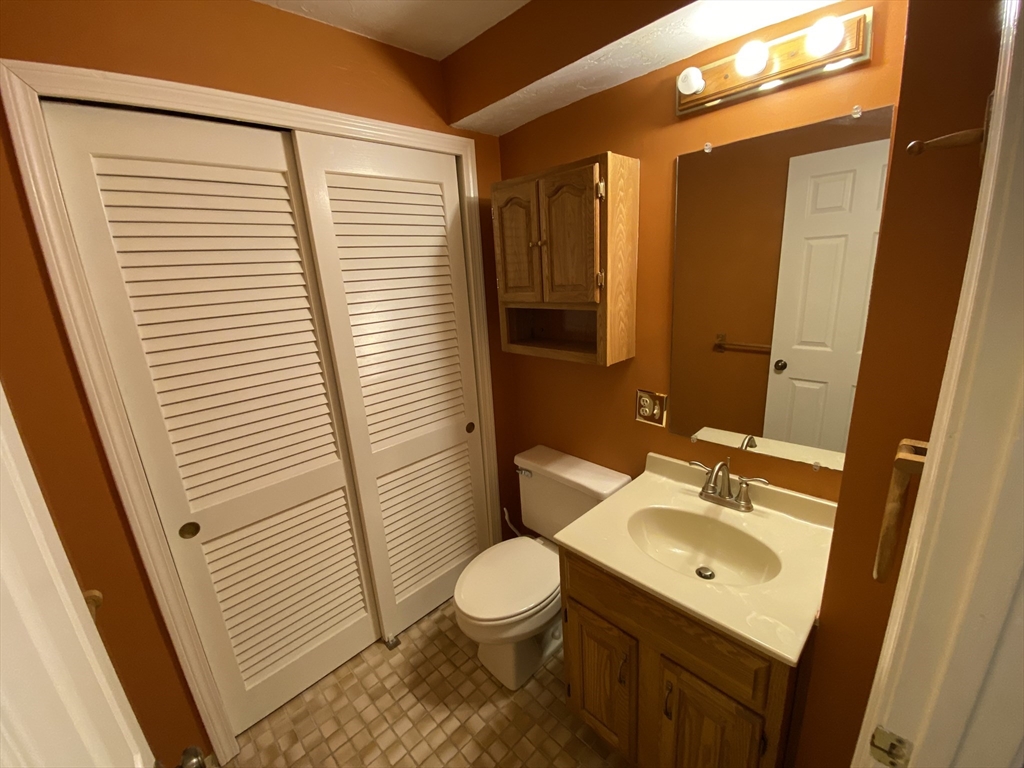 501 Ridgefield Circle, Unit B Clinton, MA 01510 - Photo 10 of 17 a bathroom with a sink a toilet a mirror and shower