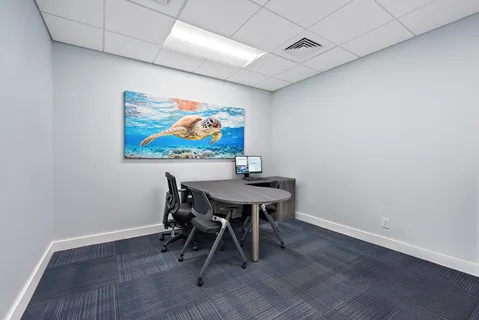 a view of a workspace with furniture and wooden floor
