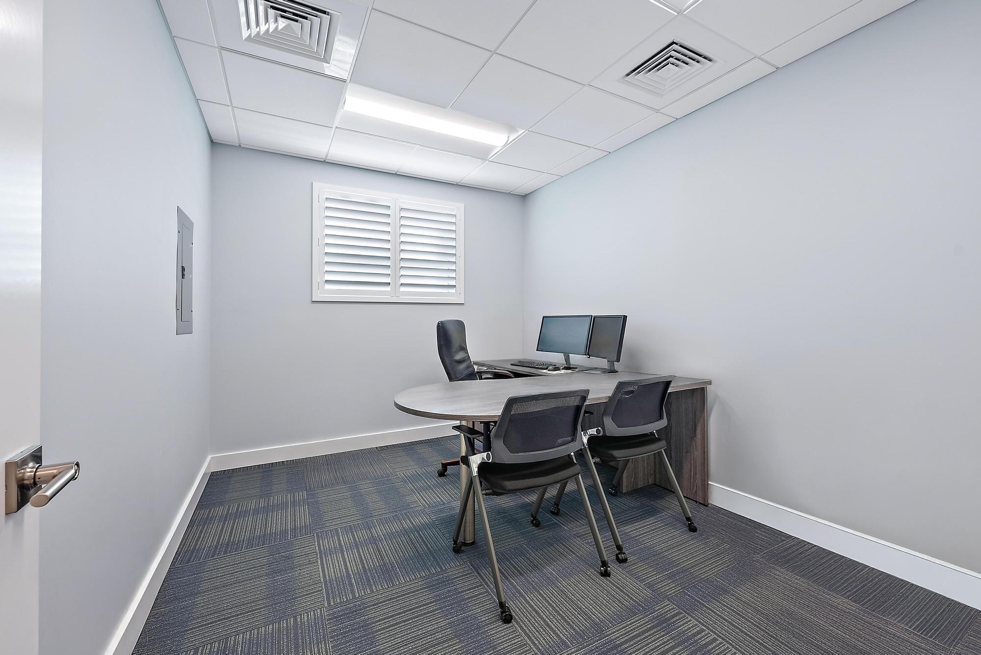 1125 Old Dixie Highway, Unit 4&5 Lake Park, FL 33403 - Photo 15 of 32 a workspace with furniture and wooden floor