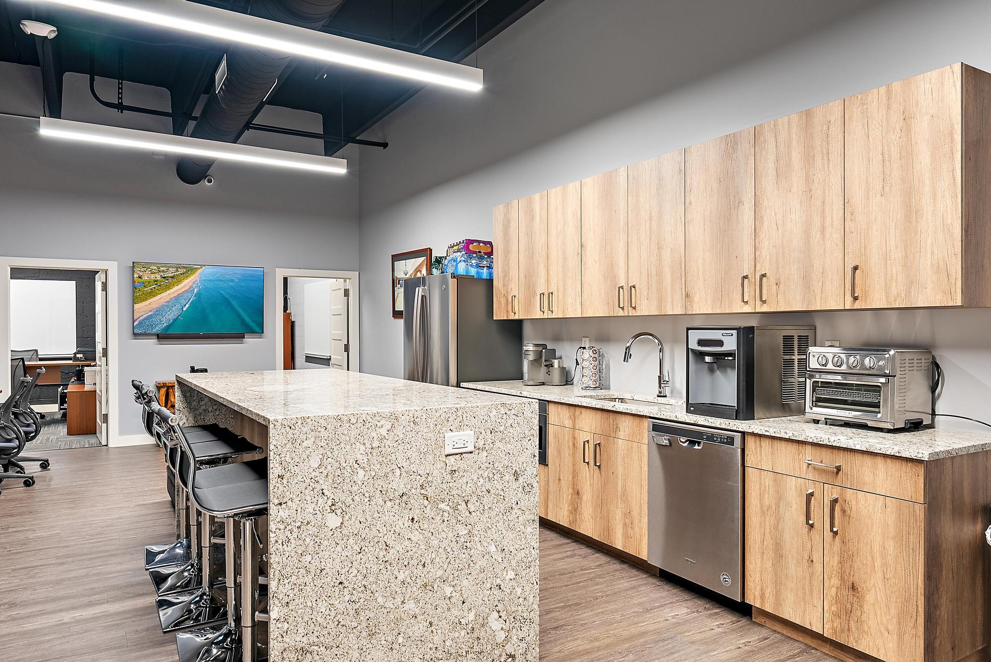 1125 Old Dixie Highway, Unit 4&5 Lake Park, FL 33403 - Photo 22 of 32 a kitchen with stainless steel appliances granite countertop a stove a sink dishwasher and white cabinets with wooden floor