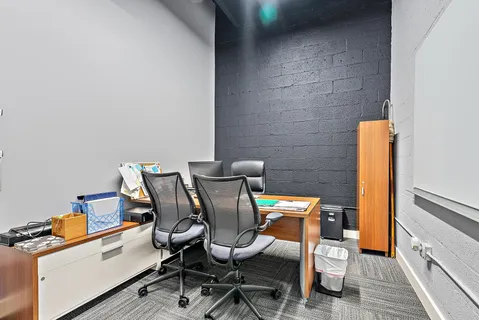 a view of kitchen with furniture and a refrigerator