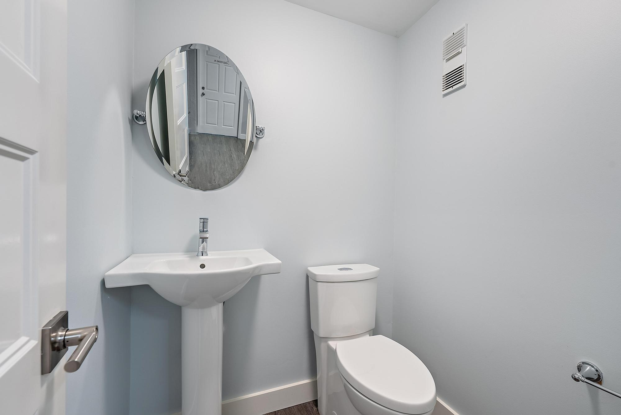 1125 Old Dixie Highway, Unit 4&5 Lake Park, FL 33403 - Photo 26 of 32 a bathroom with a toilet sink and mirror