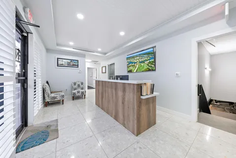 a dining room with wooden floor and stainless steel appliances